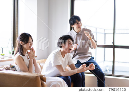 Young men and women who get excited by watching sports 79816320