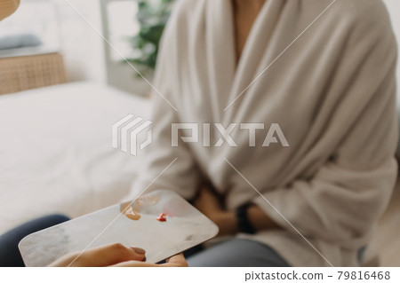 Makeup artist is using makeup tools applying to the client. Makeup artist is using makeup tools applying to the client. 79816468