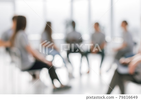 background image of a group of young people sitting in a circle 79816649