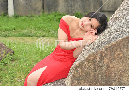 Woman sitting on a rock Woman sitting on a rock 79816771
