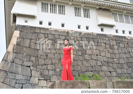 Woman standing on the stone wall Woman standing on the stone wall 79817000