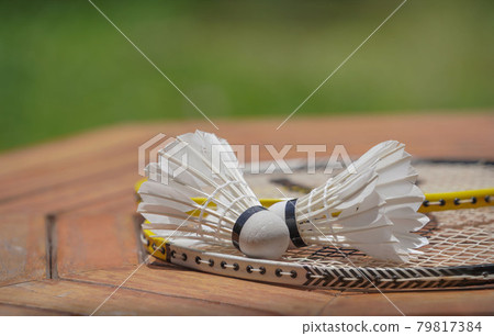 Two shuttlecocks and badminton racket. Two shuttlecocks and badminton racket. 79817384
