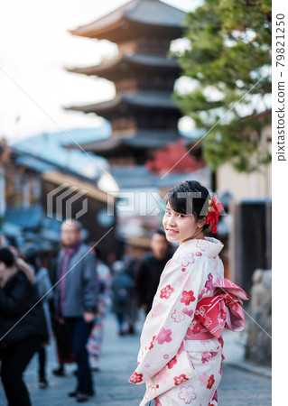 young woman tourist wearing kimono enjoy in Yasaka pagoda area near Kiyomizu dera temple, Kyoto, Japan. Asian girl with hair style in traditional Japanese clothes in Autumn foliage season 79821250