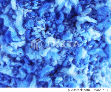 Natural woolen fabric fragment. Knitted texture closeup. Warm yarn background. Natural woolen fabric fragment. Knitted texture closeup. Warm yarn background. 79821497