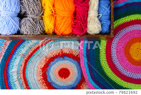 Knitted mat and colorful skeins of wollen yarn Knitted mat and colorful skeins of wollen yarn 79821692