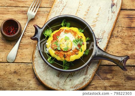 Baked stuffed patisson on rural wooden table 79822303