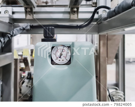 Close-up Pressure Gauge of Hotmelt Gluing Unit with the Pressure Setting of 6 Bars Close-up Pressure Gauge of Hotmelt Gluing Unit with the Pressure Setting of 6 Bars 79824005