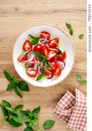 Tomato salad with onion, fresh basil and olive oil, top view Tomato salad with onion, fresh basil and olive oil, top view 79824254