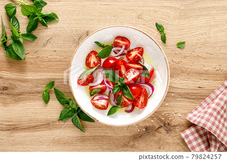 Tomato salad with onion, fresh basil and olive oil, top view Tomato salad with onion, fresh basil and olive oil, top view 79824257