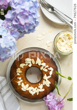 Round bundt cake, homemade pastry cake with coffee cup and flowers on background. Step by step recipe. Round bundt cake, homemade pastry cake with coffee cup and flowers on background. Step by step recipe. 79827626