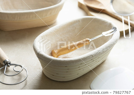 Rattan banneton, proofing basket for sourdough bread. Baking utensile. Basic set of baking bread at home. Rattan banneton, proofing basket for sourdough bread. Baking utensile. Basic set of baking bread at home. 79827767