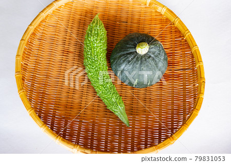 Harvesting in the vegetable garden. Freshly picked bitter gourd and pumpkin 79831053