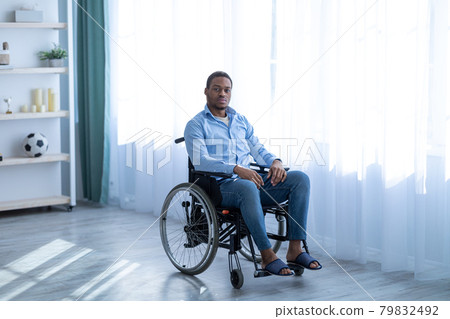 Depression in disabled patients. Portrait of paraplegic black man in wheelchair having psychological problems at home Depression in disabled patients. Portrait of paraplegic black man in wheelchair having psychological problems at home 79832492