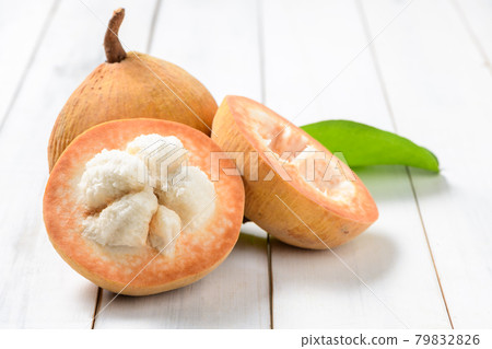 Half Santol on wood background, Santol has sour taste 79832826