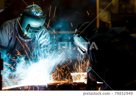 welder with protective equipment in factory welder with protective equipment in factory 79832949