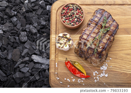 Piece of cooked rump steak with spices served Piece of cooked rump steak with spices served 79833193