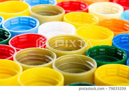 Plastic bottle caps background. Cap material is recyclable. 79833209