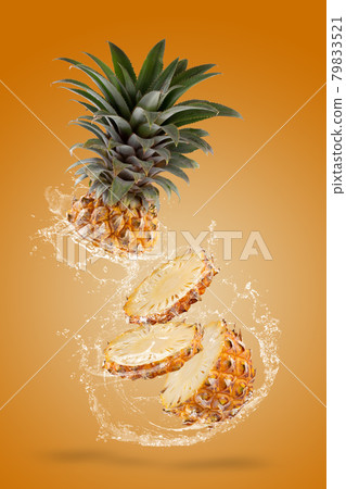 Water Splashing on Split Pineapple Fruit isolated over yellow background. 79833521
