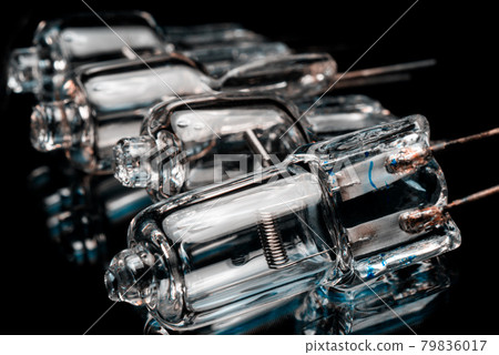 Several halogen small incandescent lamps with a blurry background Several halogen small incandescent lamps with a blurry background 79836017