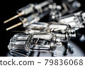 Several halogen small incandescent lamps with a blurry background 79836068