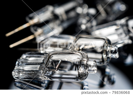 Several halogen small incandescent lamps with a blurry background Several halogen small incandescent lamps with a blurry background 79836068