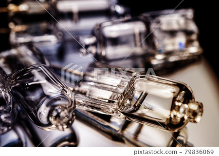 Several halogen small incandescent lamps with a blurry background 79836069