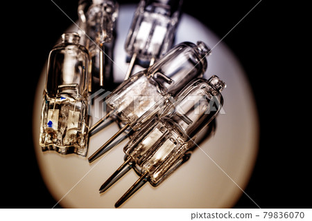 Several halogen small incandescent lamps with a blurry background Several halogen small incandescent lamps with a blurry background 79836070