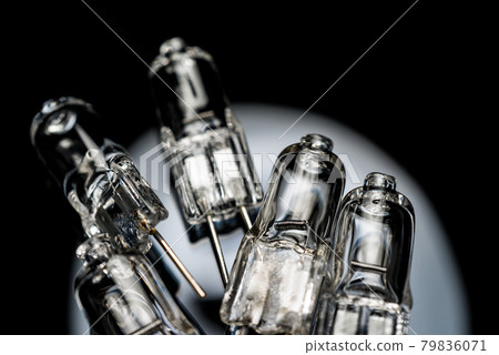 Several halogen small incandescent lamps with a blurry background Several halogen small incandescent lamps with a blurry background 79836071