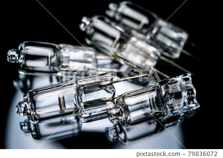 Several halogen small incandescent lamps with a blurry background Several halogen small incandescent lamps with a blurry background 79836072