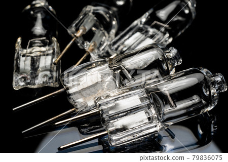 Several halogen small incandescent lamps with a blurry background 79836075