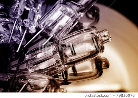 Several halogen small incandescent lamps with a blurry background Several halogen small incandescent lamps with a blurry background 79836076