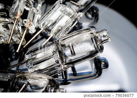 Several halogen small incandescent lamps with a blurry background Several halogen small incandescent lamps with a blurry background 79836077