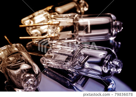 Several halogen small incandescent lamps with a blurry background Several halogen small incandescent lamps with a blurry background 79836078