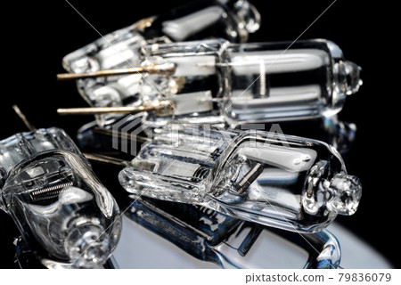 Several halogen small incandescent lamps with a blurry background 79836079