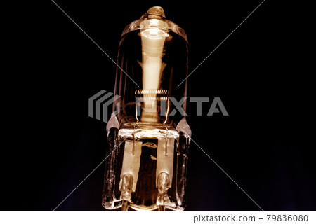 Several halogen small incandescent lamps with a blurry background Several halogen small incandescent lamps with a blurry background 79836080