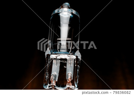 Several halogen small incandescent lamps with a blurry background Several halogen small incandescent lamps with a blurry background 79836082