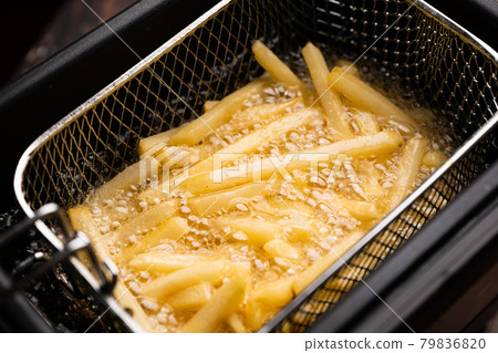 friing potatos in fryier  for french fries 79836820