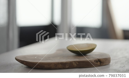 Ripe mango on olive board on white oak table Ripe mango on olive board on white oak table 79837031