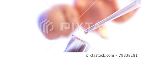 Chemical test tube and pipette with a drop of liquid in a chemical laboratory. A baby is reflected in a drop of liquid. Fertilization concept 79838181