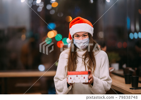 Portrait happy young beautiful woman, hold gift box and smile in cafe. Portrait happy young beautiful woman, hold gift box and smile in cafe. 79838748