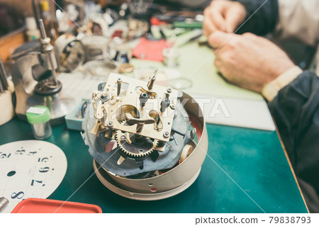 Close up on clockwork of clock to be repaired in watchmaker workshop 79838793
