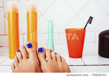 woman legs in bathroom with lot of stylish stuff for care, pedicure creative design, hygiene spa mani pedi concept woman legs in bathroom with lot of stylish stuff for care, pedicure creative design, hygiene spa mani pedi concept 79840543