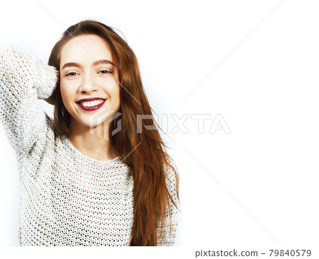 young pretty teenage hipster girl posing emotional happy smiling on white background, lifestyle people concept 79840579