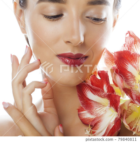 young pretty brunette real woman with red flower amaryllis close up isolated on white background. Fancy fashion makeup, bright lipstick, creative Ombre manicured nails young pretty brunette real woman with red flower amaryllis close up isolated on white background. Fancy fashion makeup, bright lipstick, creative Ombre manicured nails 79840811