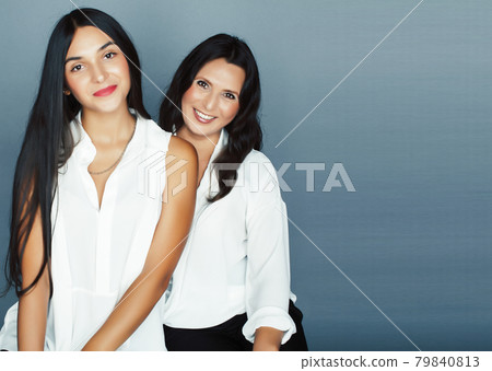 cute pretty teen daughter with mature mother hugging, fashion style brunette, lifestyle people concept cute pretty teen daughter with mature mother hugging, fashion style brunette, lifestyle people concept 79840813