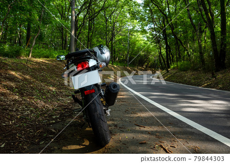 Summer bike touring Curve of sunlight through the forest a-1 Summer bike touring Curve of sunlight through the forest a-1 79844303
