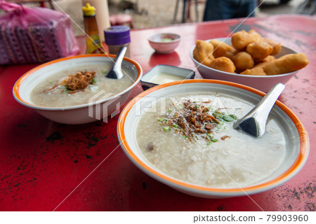 A set of rice congees on table. Rice congee in Thailand known as 'chok' is a type of rice porridge served as breakfast topped with egg, pork, fried garlic etc. A set of rice congees on table. Rice congee in Thailand known as 'chok' is a type of rice porridge served as breakfast topped with egg, pork, fried garlic etc. 79903960