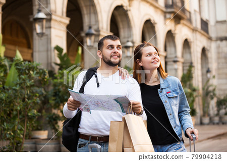 Tourists walking with map at street 79904218