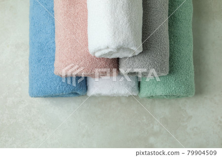 Clean rolled towels on textured background, top view 79904509