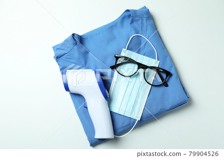 Medical tools and thermometer gun on white background 79904526